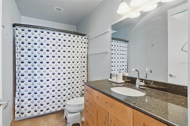 full bathroom featuring vanity, a shower with curtain, visible vents, tile patterned flooring, and toilet