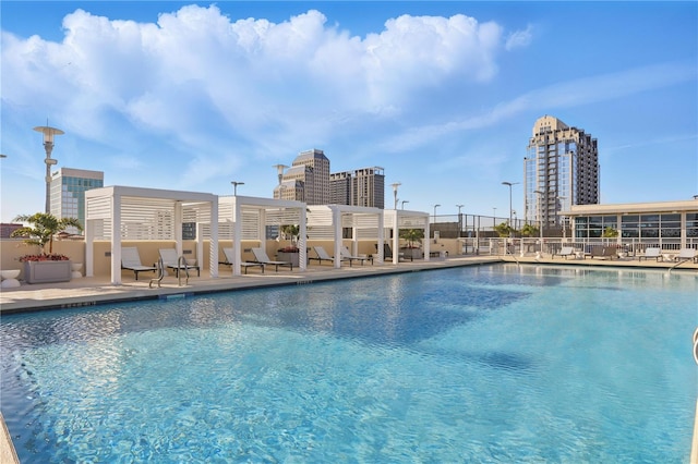 pool featuring a view of city and a patio area