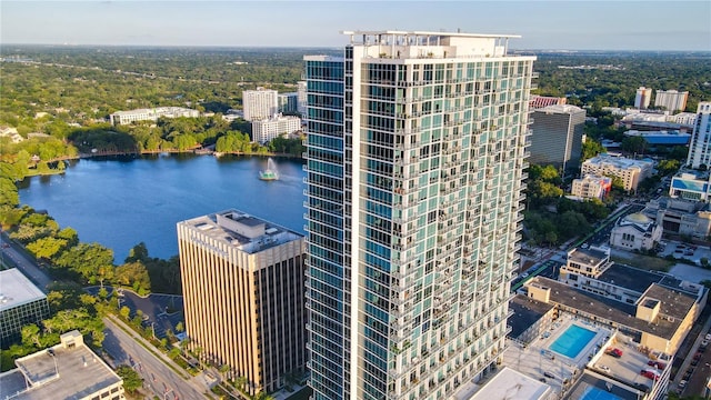 drone / aerial view featuring a city view and a water view