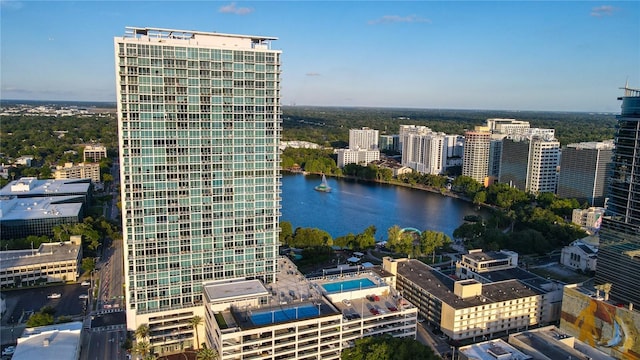 drone / aerial view featuring a city view and a water view