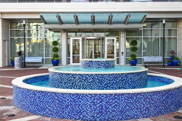 exterior space featuring a pool with connected hot tub