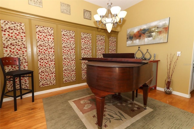 interior space with wood finished floors, baseboards, and a chandelier