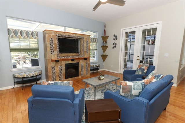 living room with ceiling fan, french doors, a healthy amount of sunlight, and wood finished floors