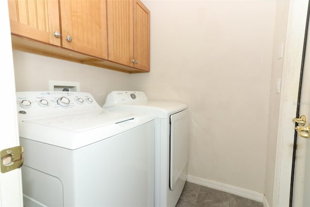 laundry area featuring baseboards, cabinet space, washing machine and dryer, and tile patterned flooring