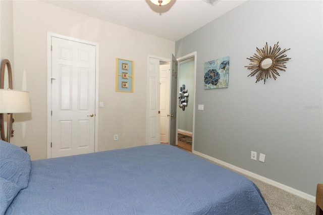 carpeted bedroom with baseboards