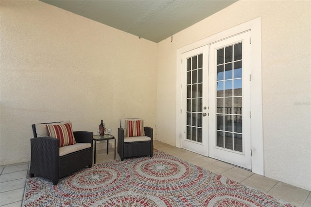 sitting room with tile patterned flooring and french doors