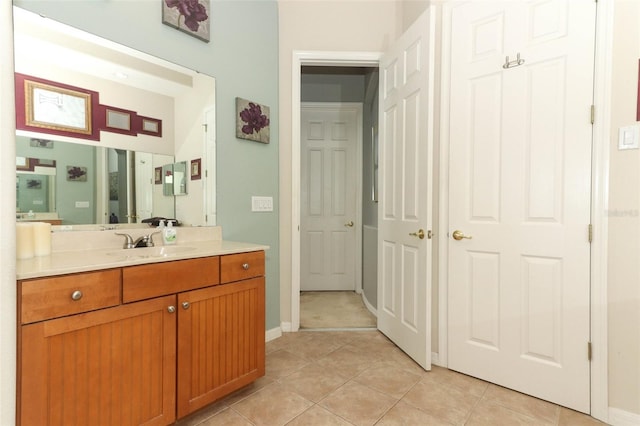 bathroom featuring tile patterned floors, vanity, and baseboards