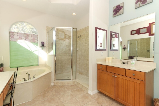 full bath featuring a bath, tile patterned flooring, a stall shower, and vanity