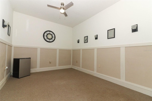 spare room with carpet and a ceiling fan