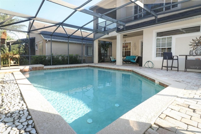 outdoor pool with glass enclosure and a patio area