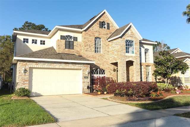 traditional-style home with stone siding, roof with shingles, and concrete driveway