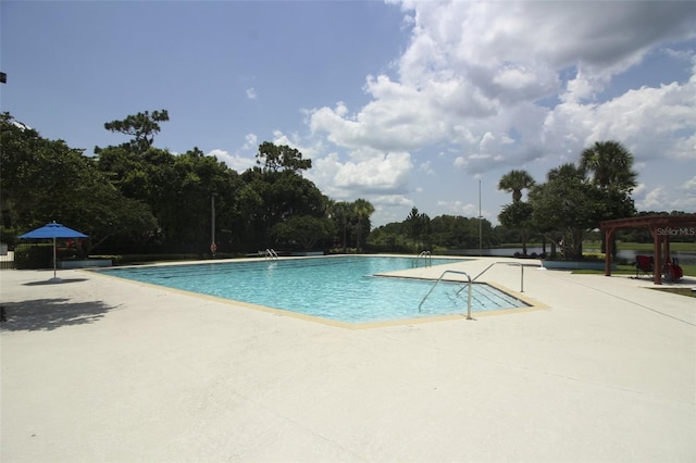 community pool featuring a pergola and a patio