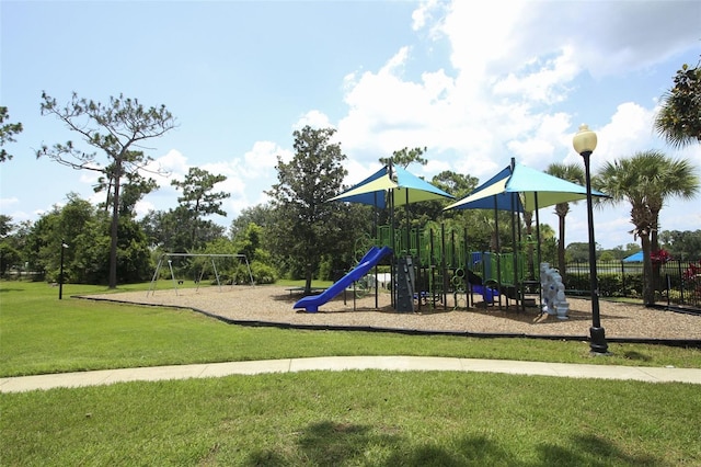 communal playground with a lawn and fence