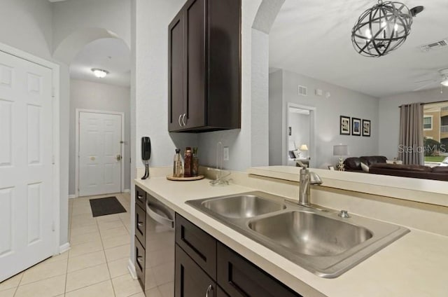 kitchen featuring visible vents, a sink, stainless steel dishwasher, open floor plan, and dark brown cabinets