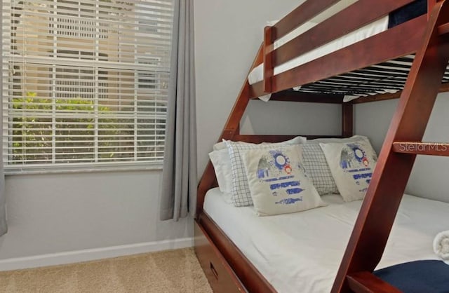 bedroom featuring carpet flooring and baseboards