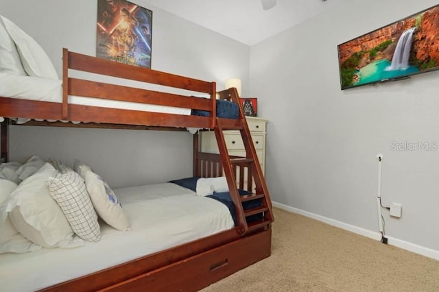 bedroom with carpet flooring, a ceiling fan, and baseboards