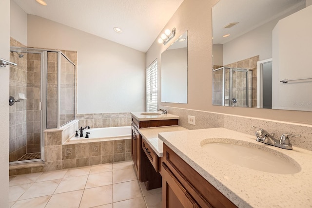 full bathroom featuring a sink, lofted ceiling, a stall shower, and tile patterned flooring