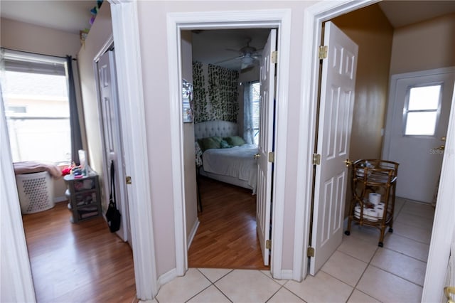 corridor with plenty of natural light and light tile patterned floors