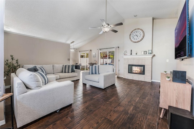 living area featuring dark wood-type flooring, baseboards, ceiling fan, a fireplace, and high vaulted ceiling