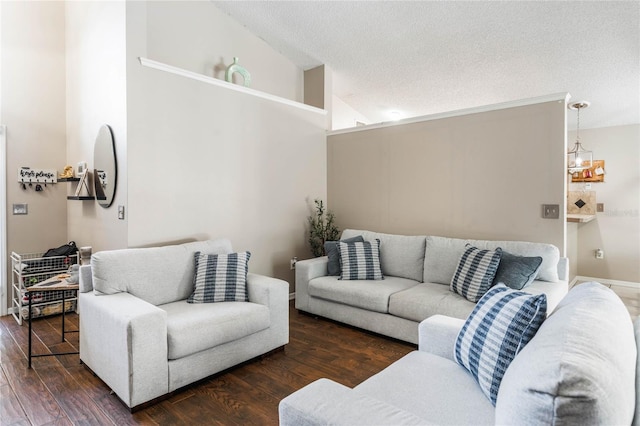 living area with a textured ceiling, high vaulted ceiling, and wood finished floors