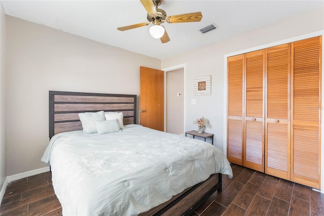 bedroom featuring a closet, visible vents, baseboards, and wood finish floors