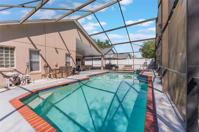 view of pool with a patio, fence, a fenced in pool, and a lanai