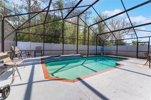 view of pool with a fenced in pool, fence, a lanai, and a patio area