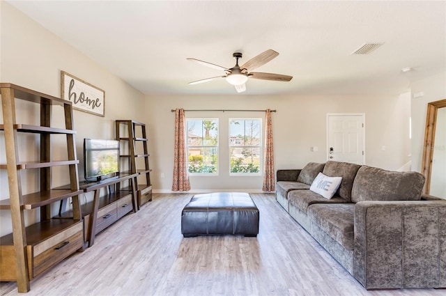living room featuring baseboards, visible vents, wood finished floors, and ceiling fan