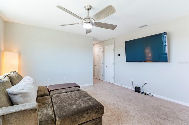 living area with baseboards, a ceiling fan, visible vents, and carpet
