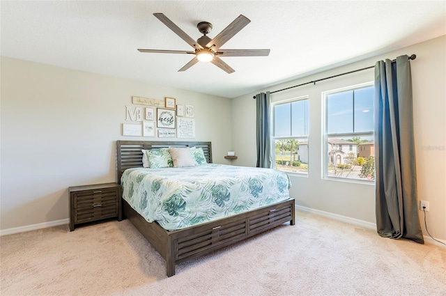 bedroom with carpet flooring, a ceiling fan, and baseboards