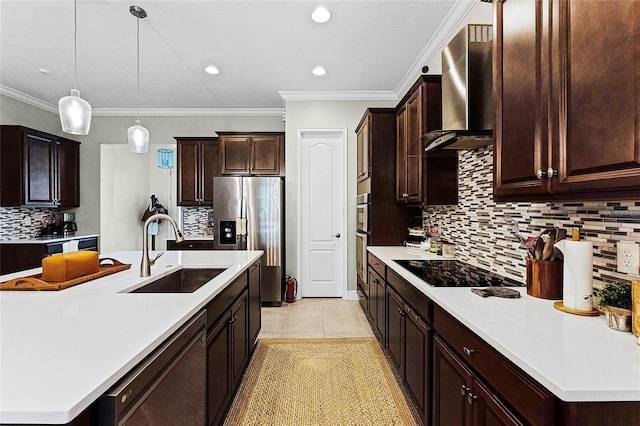 kitchen with a center island with sink, light countertops, appliances with stainless steel finishes, wall chimney exhaust hood, and a sink