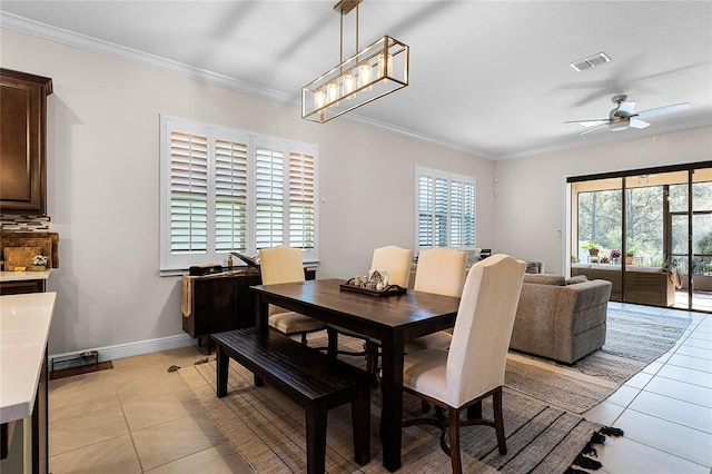 dining space featuring light tile patterned flooring, visible vents, and ornamental molding