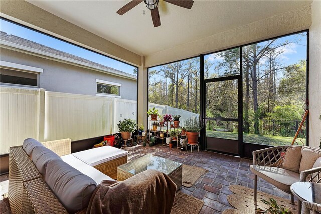 sunroom with a healthy amount of sunlight and ceiling fan