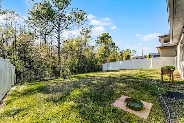 view of yard with a fenced backyard