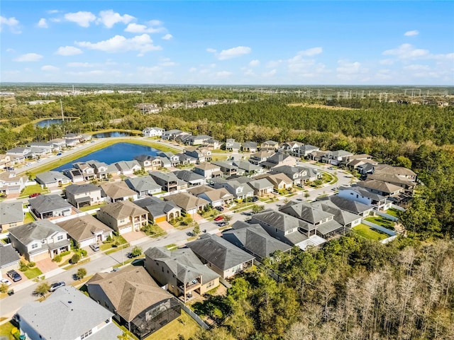 aerial view with a forest view, a residential view, and a water view