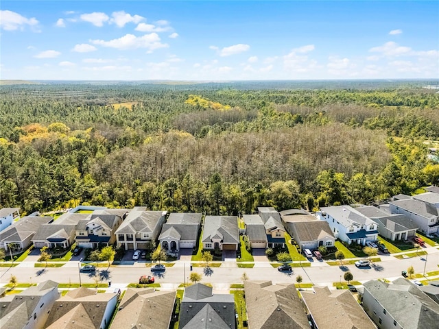 birds eye view of property featuring a forest view and a residential view