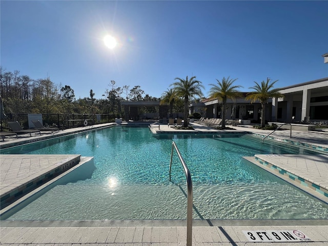 community pool featuring a patio area and fence