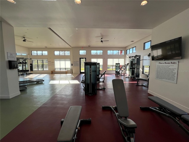 exercise room featuring a ceiling fan and baseboards