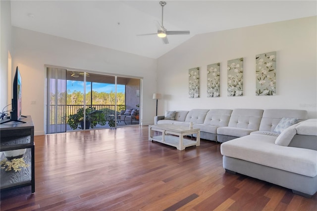 living room featuring vaulted ceiling, baseboards, a ceiling fan, and wood finished floors