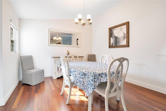 dining space with a notable chandelier, baseboards, and wood-type flooring