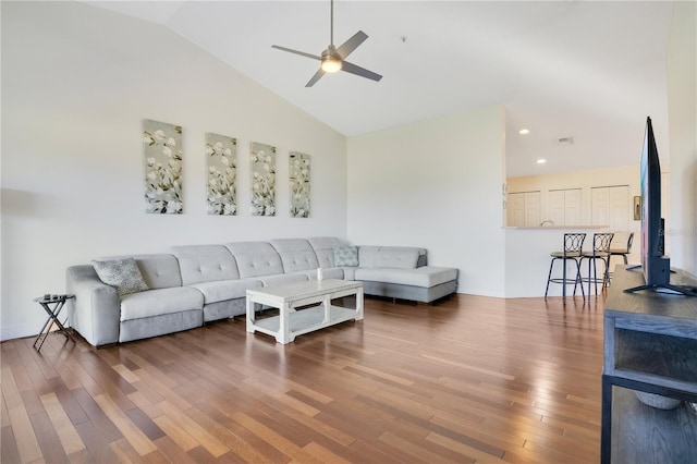 living area featuring visible vents, a ceiling fan, wood finished floors, recessed lighting, and vaulted ceiling