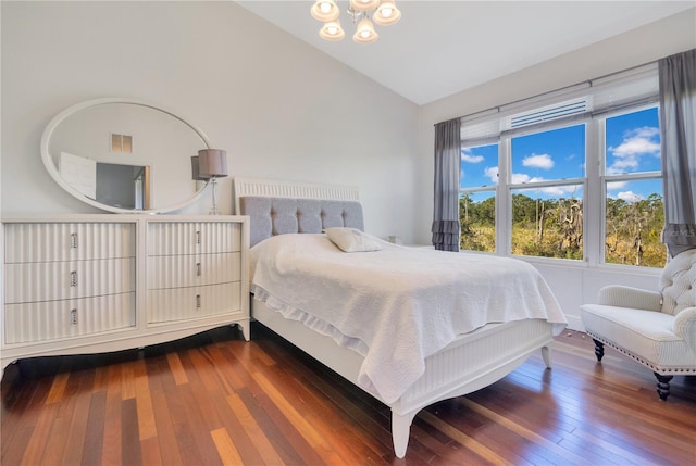 bedroom featuring visible vents, dark wood-type flooring, and vaulted ceiling