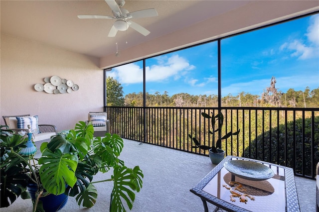 sunroom featuring ceiling fan