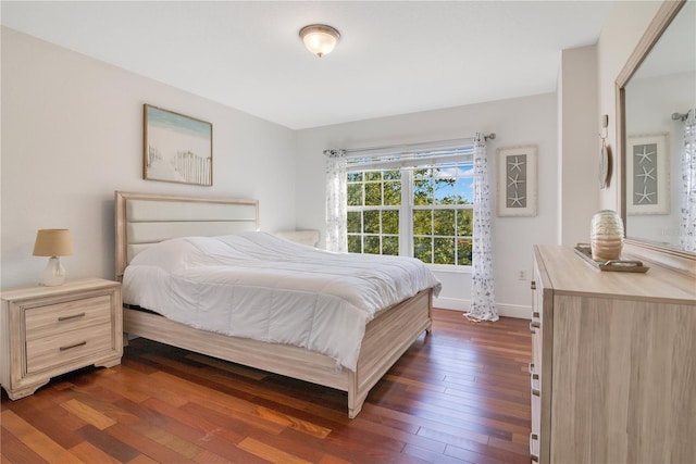 bedroom featuring dark wood-style floors and baseboards