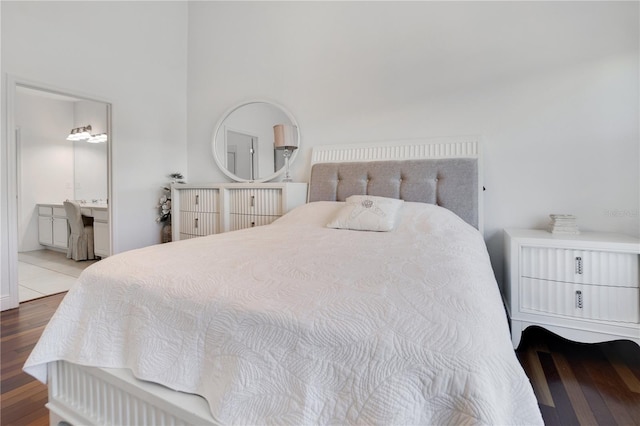 bedroom with ensuite bath and wood finished floors