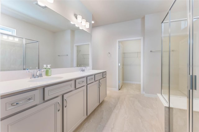 full bath featuring a sink, visible vents, a walk in closet, and a stall shower