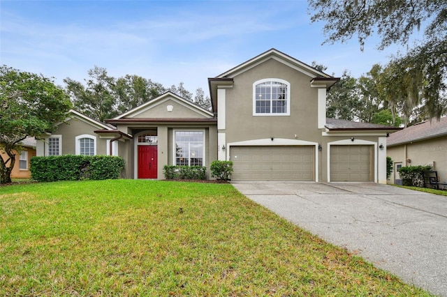 traditional home with a front yard, concrete driveway, a garage, and stucco siding