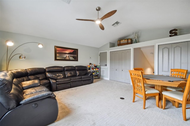 carpeted living room featuring lofted ceiling, visible vents, and ceiling fan