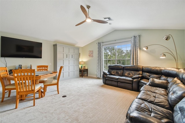 living area with visible vents, carpet, baseboards, ceiling fan, and vaulted ceiling