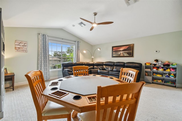 dining area featuring visible vents, light colored carpet, lofted ceiling, and ceiling fan